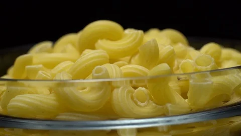 Raw macaroni in rotation. Elbow macaroni. Macaroni rigati close up. Stock Footage 101748715