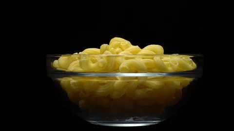 Raw macaroni in rotation. Elbow macaroni. Macaroni rigati close up. Stock Footage 101748769