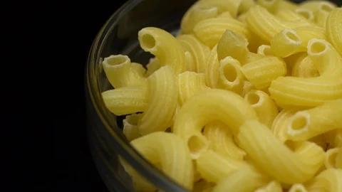 Raw macaroni in rotation. Elbow macaroni. Macaroni rigati close up. Stock Footage 101748813