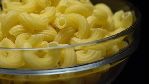 Raw macaroni in rotation. Elbow macaroni. Macaroni rigati close up. Stock Footage 101748840