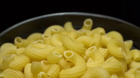 Raw macaroni in rotation. Elbow macaroni. Macaroni rigati close up. Stock Footage 101748865