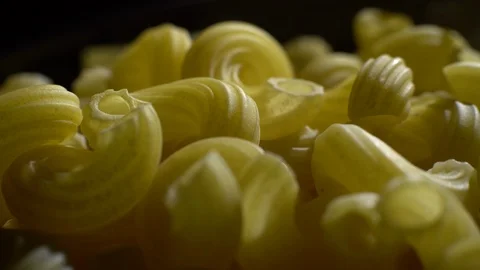Raw macaroni in rotation. Elbow macaroni. Macaroni rigati close up. Stock Footage 101749299