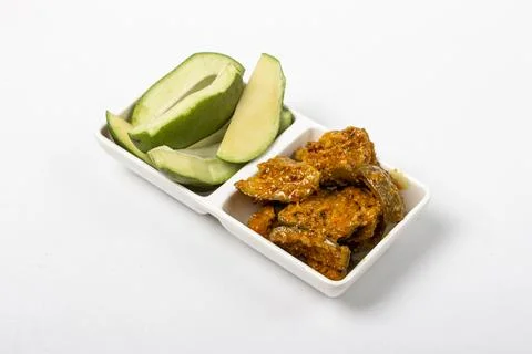 Raw Mango pieces with Pickle in tray Stock Photos