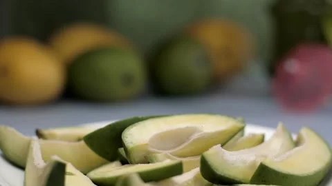 Raw mangoes on a ceramic plate rotating on a turntable - mango pickle ingredi... Stock Footage 154395925
