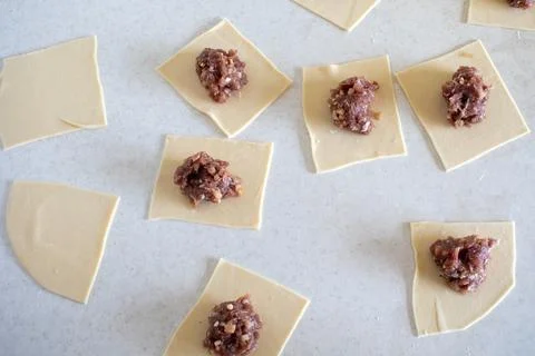 Raw Manti with meat inside (dumpling). Raw meat in the dough. Raw meat in dou Stock Photos