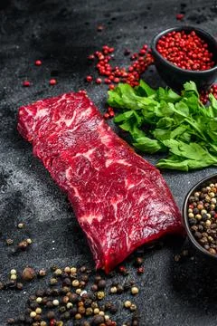 Raw marble beef meat steak. Black background. Top view Stock Photos