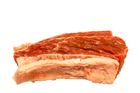 Raw marbled beef, brisket lying on white background. Isolated. Stock Photos