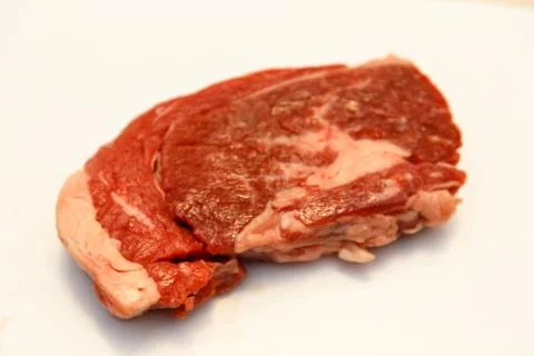 Raw marbled beef, brisket lying on white background. Isolated. Stock Photos