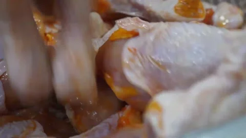 Raw Marinated Chicken Pieces with Yellow Spice Coating in Metal Bowl Video stock 343027348
