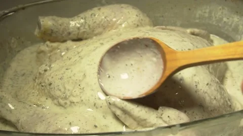 Raw marinated whole chicken for baking in the oven. Action. Close up of woman Stock Footage 138710438