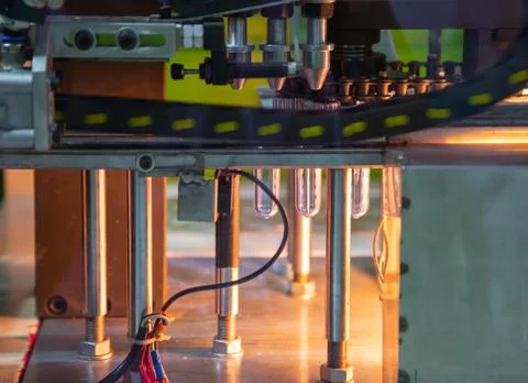 Raw material of plastic bottle on blowing machine Stock Photos