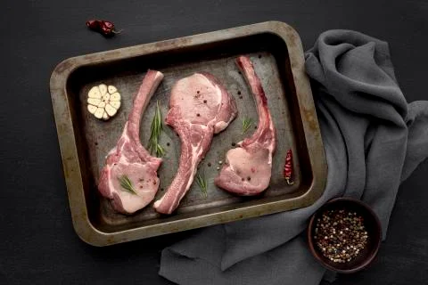 Raw meat in baking pan on table Photo Stock Photos