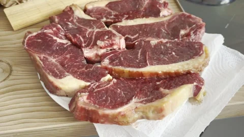Raw meat beef steaks on plate Stock Footage 310997780