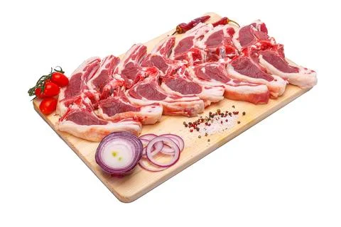 Raw meat brisket, beef bone, wooden cutting board, white isolated background Stock Photos