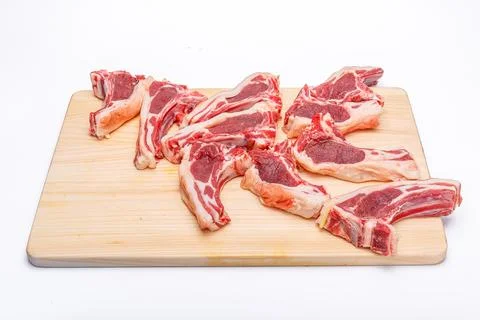 Raw meat brisket, beef bone, wooden cutting board, white isolated background Stock Photos