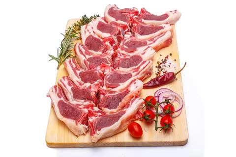Raw meat brisket, beef bone, wooden cutting board, white isolated background Stock Photos