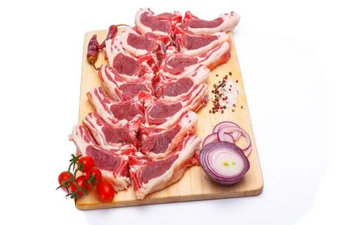 Raw meat brisket, beef bone, wooden cutting board, white isolated background Stock Photos