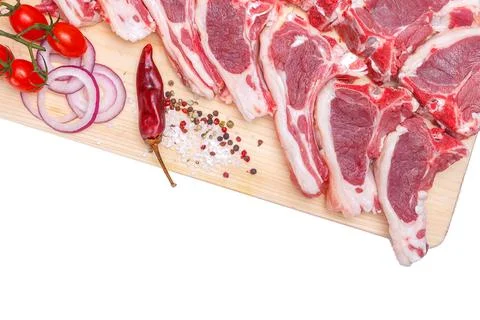 Raw meat brisket, beef bone, wooden cutting board, white isolated background Stock Photos