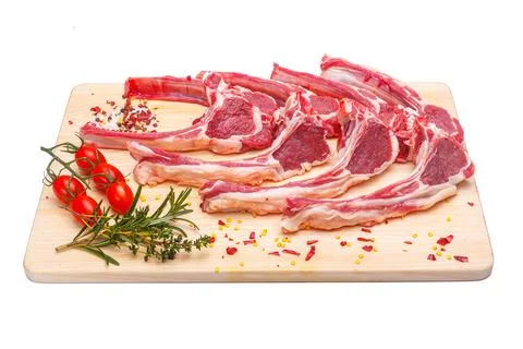 Raw meat brisket, beef bone, wooden cutting board, white isolated background Stock Photos
