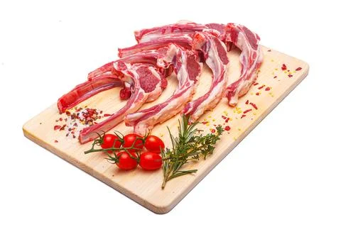 Raw meat brisket, beef bone, wooden cutting board, white isolated background Stock Photos