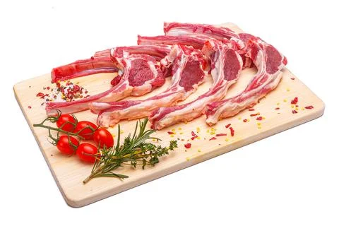 Raw meat brisket, beef bone, wooden cutting board, white isolated background Stock Photos