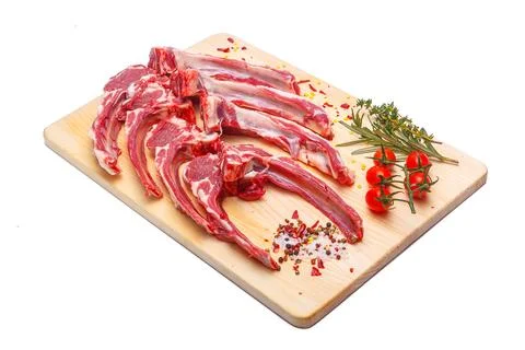 Raw meat brisket, beef bone, wooden cutting board, white isolated background Stock Photos