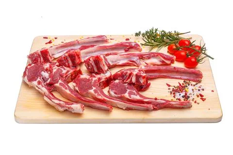 Raw meat brisket, beef bone, wooden cutting board, white isolated background Stock Photos