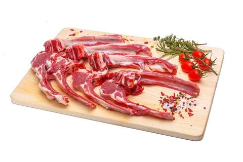 Raw meat brisket, beef bone, wooden cutting board, white isolated background Stock Photos