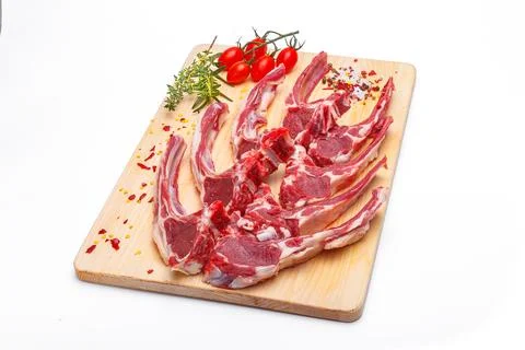 Raw meat brisket, beef bone, wooden cutting board, white isolated background Stock Photos
