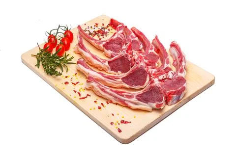 Raw meat brisket, beef bone, wooden cutting board, white isolated background Stock Photos