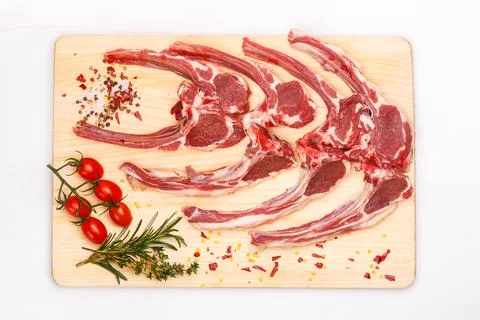 Raw meat brisket, beef bone, wooden cutting board, white isolated background Stock Photos