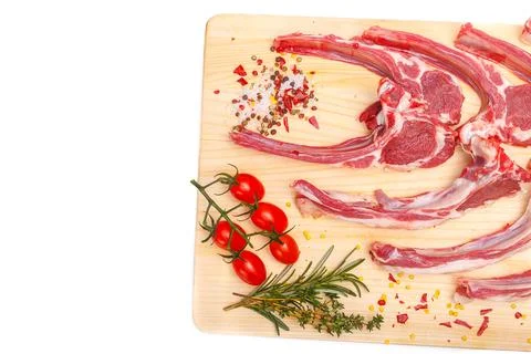 Raw meat brisket, beef bone, wooden cutting board, white isolated background Stock Photos