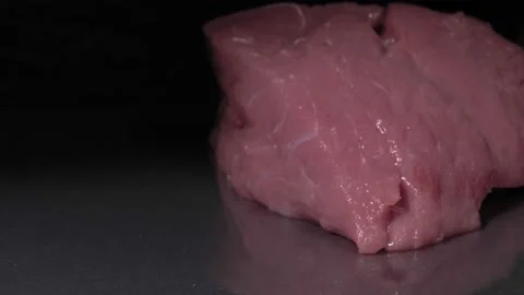 Raw meat close-up. Black background. 動画素材 144352935