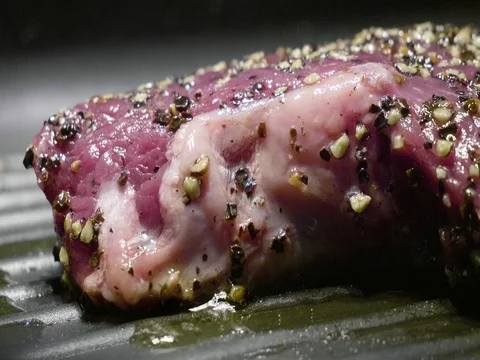 Raw meat cooking on pan Stock Footage 77044729