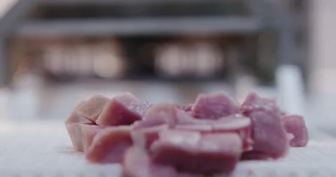 Raw meat cubes lying on a bright work surface in a kitchen, Food Factory Stock Footage 340036275