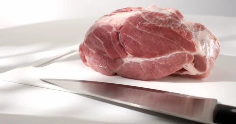 Raw meat on a cutting board with a knife. piece of fresh pork. farm product. Stock Footage 242495885