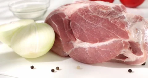 Raw meat on a cutting board with onions. piece of fresh pork. farm products. Stock Footage 242495838