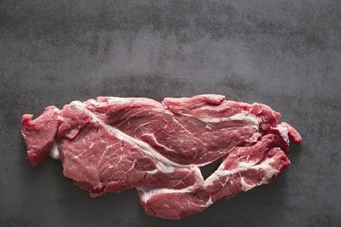 Raw meat on a dark background Stock Photos