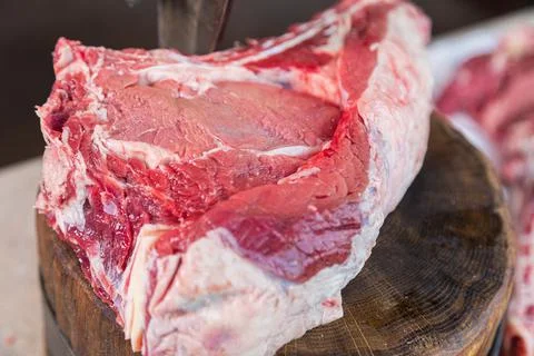 Raw meat on a deck for making lunch. Fresh meat on a cutting board. Stock Photos