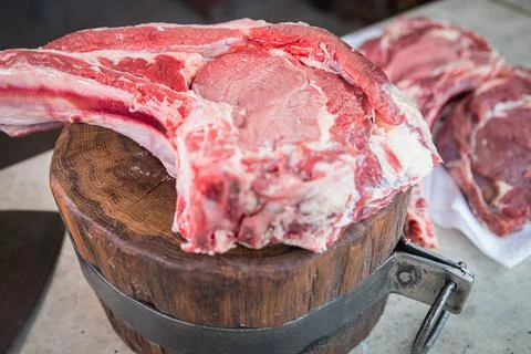Raw meat on a deck for making lunch. Fresh meat on a cutting board. Stock Photos