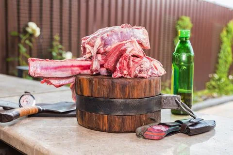 Raw meat on a deck for making lunch. Fresh meat on a cutting board with olive Stock Photos