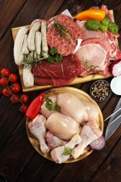 Raw meat. Different types of raw pork meat, chicken and beef with spices and  Stock Photos