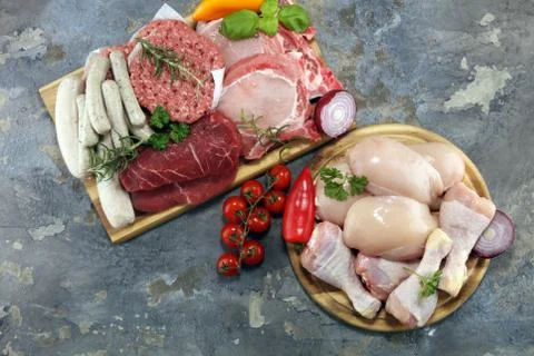 Raw meat. Different types of raw pork meat, chicken and beef with spices and  Stock Photos