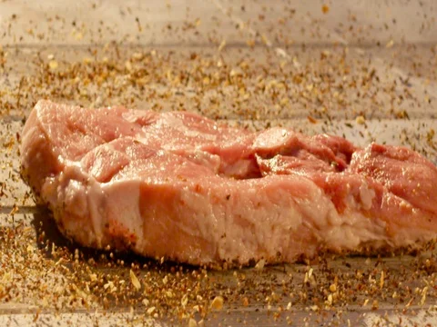 Raw meat is falling in spices Stock Footage 83907768