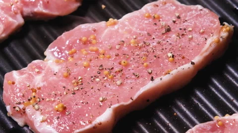 Raw Meat is fried on an electric grill close up. 4K resolution video. Pork Stock-Footage 166244641