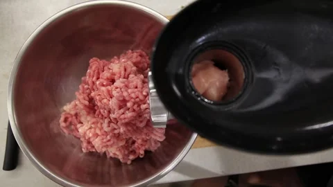Raw meat grinding process with electric meat grinder, fresh chicken meat being 動画素材 329213323