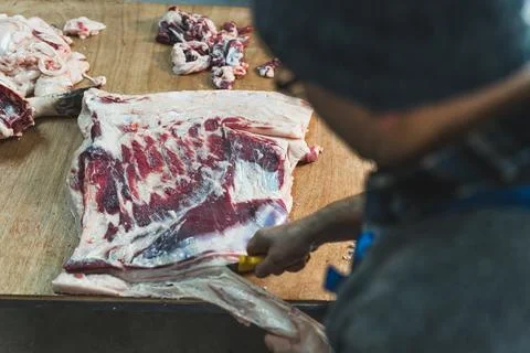 Raw meat industry worker, back view, slaughterhouse, pig meat oncept Stock Photos