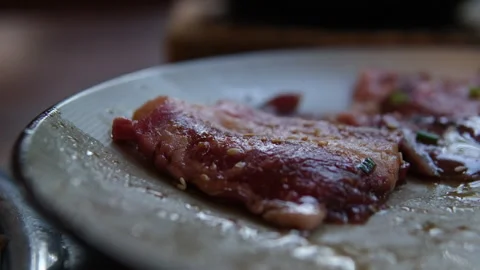 Raw meat marinated by the chef. The chef sprinkles the steak with spices Stock Footage 312012812