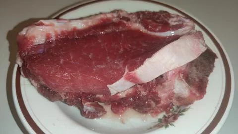 Raw meat on the plate Stock Photos
