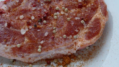 Raw meat is ready to grill-sprinkled with red pepper, salt Stock Footage 97710269